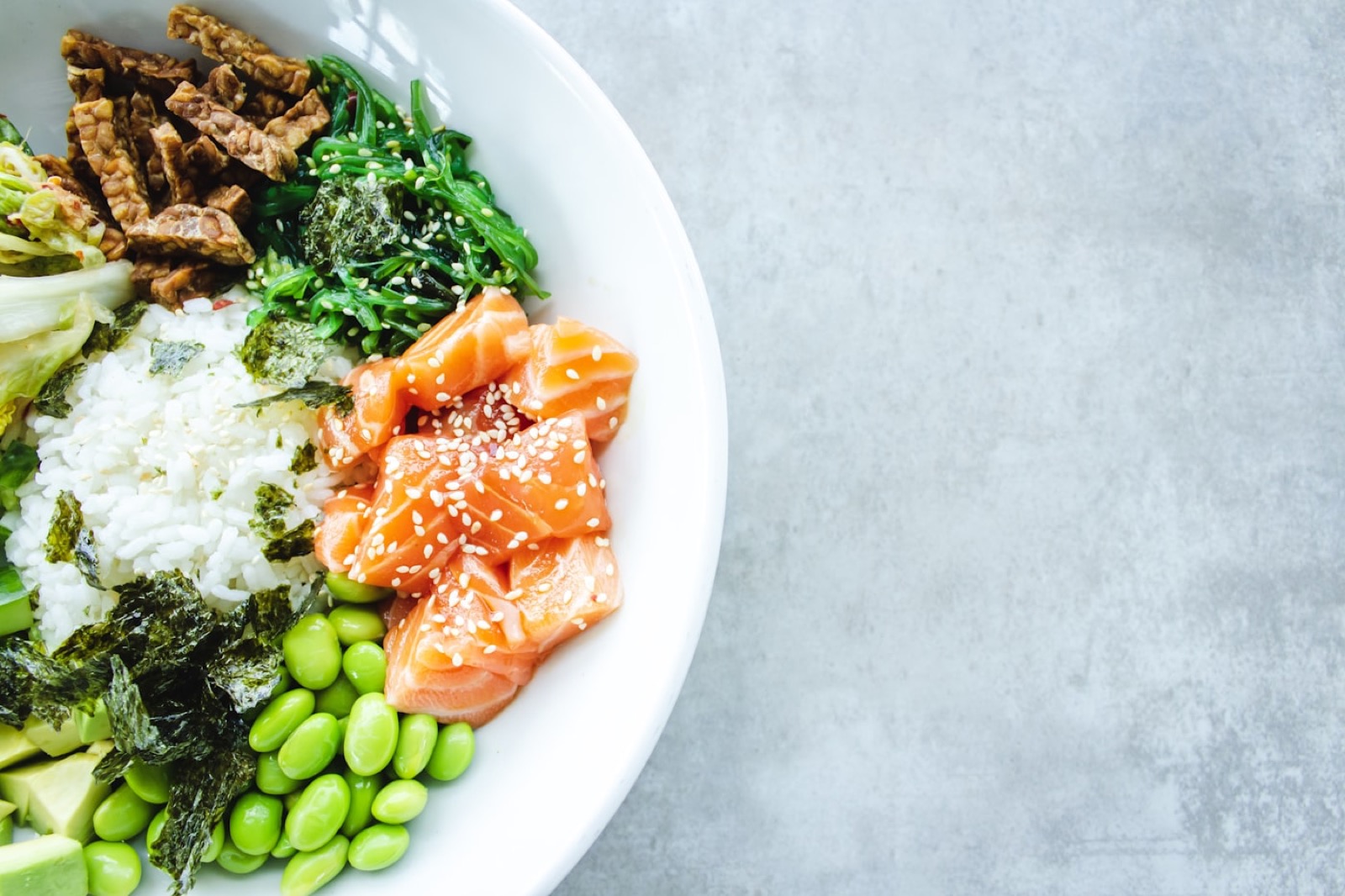 A spritz on a wooden table with greenery.